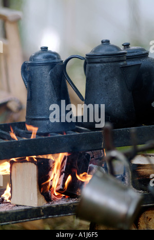 https://l450v.alamy.com/450v/a1j6f5/cowboy-coffee-pot-boiling-over-open-campfire-burn-steam-cook-camping-a1j6f5.jpg