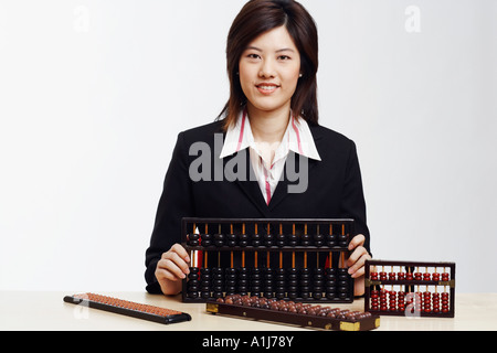 Portrait of a businesswoman holding an abacus Stock Photo
