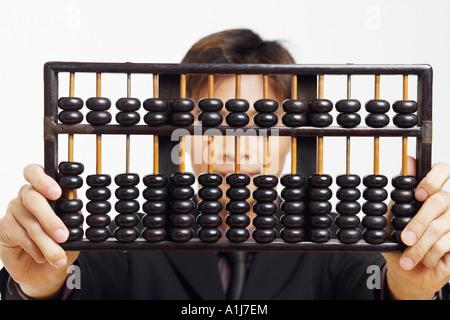 Close-up of a businessman holding an abacus Stock Photo