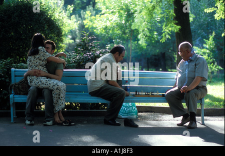 Young lovers and chess players on park bench in Amir Temur Gardens Tashkent Uzbekistan Stock Photo