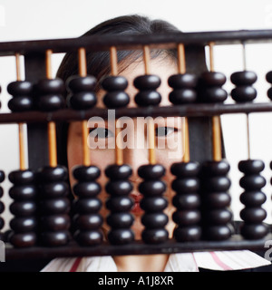 Portrait of a businesswoman holding an abacus and smiling Stock Photo