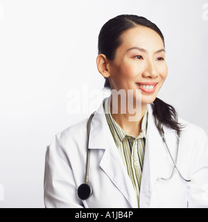 Close-up of a female doctor holding a clipboard and smiling Stock Photo