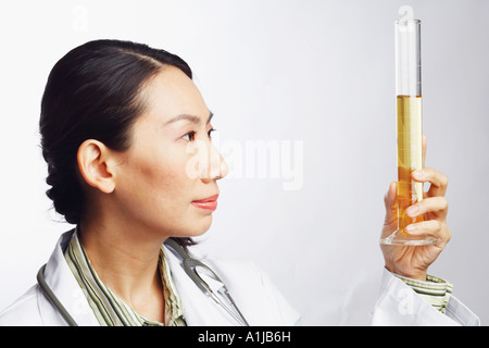 Close-up of a female doctor holding a graduated cylinder Stock Photo
