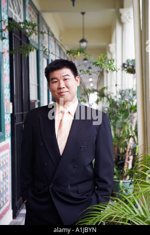 Portrait of a businessman standing in the corridor and smirking Stock Photo