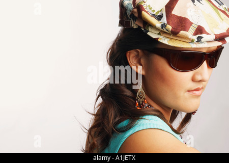 Side profile of a young woman wearing a pair of sunglasses