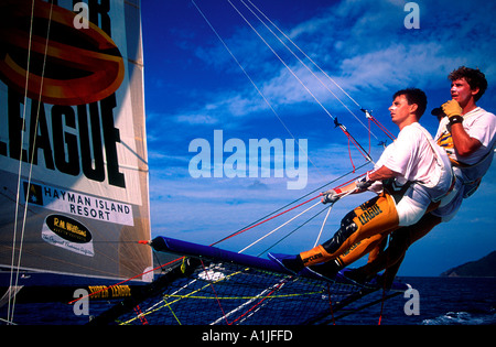 18 foot skiff racing with crew of three on trapeze at Hayman Island Queensland Australia Stock Photo