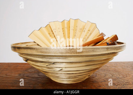 Close-up of folding fans in a basket Stock Photo