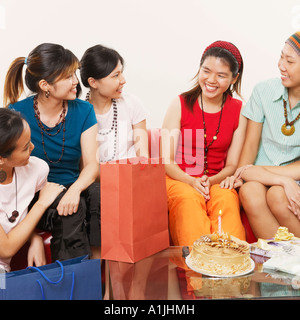 Young woman smiling with her friends at her birthday party Stock Photo