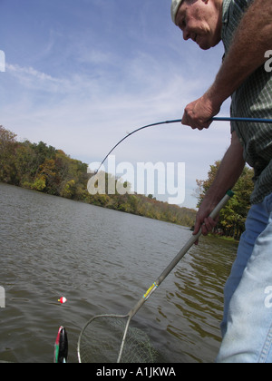 Fake Bait For Fishing,Orange Rubber Worm On The Hands Of Fishermen