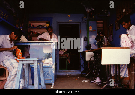 Men working in a tailor workshop Tamil Nadu South India Stock Photo