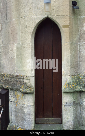 Narrow arched brown door St Nicholas Church Bathampton Bath Spa, Somerset, England  UK Stock Photo