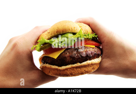 Hands holding big hamburger Stock Photo