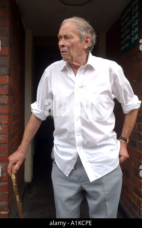 Elderly man leaving home on a housing estate in the East End of London Stock Photo