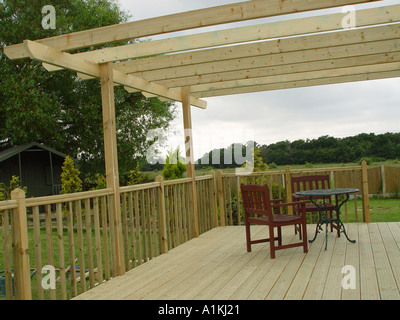 Pergola over garden patio deck the decking and pergola are constructed from tanalised timber for long life Stock Photo