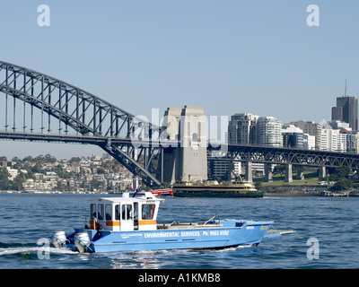 SYDNEY HARBOUR WITH BRIDGE WITH A NSW MARITIME ENVIRONMENTAL SERVICES BOAT IN FOREGROUND SYDNEY NEW SOUTH WALES AUSTRALIA Stock Photo