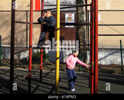 Hispanic Boy and Girl playing on the Playground Gym Bars, New York City, USA Stock Photo