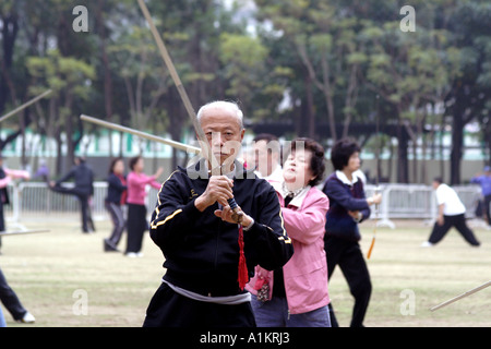 Armed excercise.  Man practicing Tai Chi with a sword in Victoria Park, Hong Kong Stock Photo