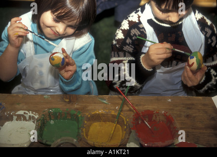 CHRISTIANITY children painting Easter eggs in England Stock Photo