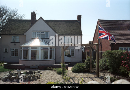 Union Jack flag flies proudly in a garden, Cromer, UK Stock Photo