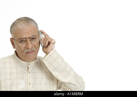 Senior citizen talking on mobile phone white background Stock Photo