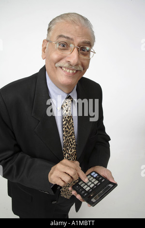 Senior citizen working on calculator wearing business suit Stock Photo