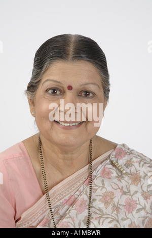 Indian senior citizen with dot on forehead in sari looking at camera