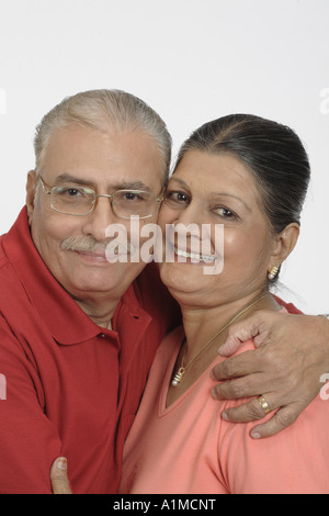 Indian senior citizen couple looking lovingly on white background Stock Photo