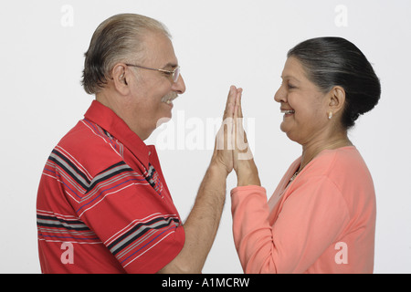 Loving Indian senior citizen couple playing clap your hands Stock Photo