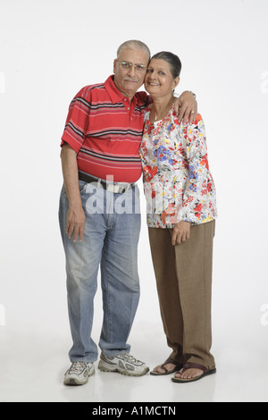 Loving Indian senior citizen couple standing in embrace Stock Photo