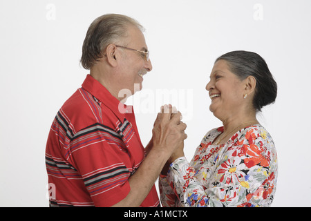 Loving Indian senior citizen couple standing holding hands Stock Photo