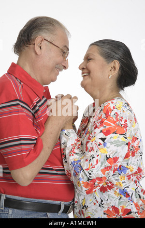 Loving Indian senior citizen couple standing holding hands Stock Photo