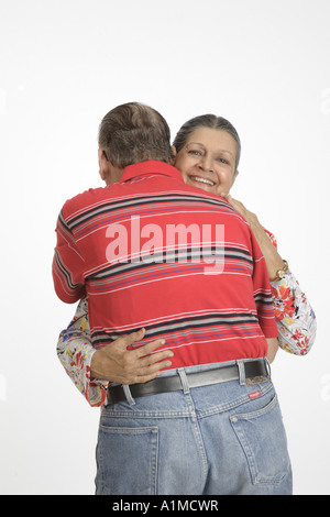 Loving Indian senior citizen couple standing embracing each other Stock Photo