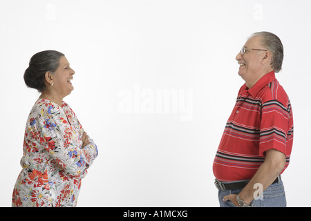 Loving Indian senior citizen couple standing apart looking at each other Stock Photo