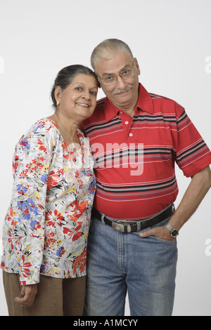 Loving Indian senior citizen couple wife head on husbands shoulder Stock Photo