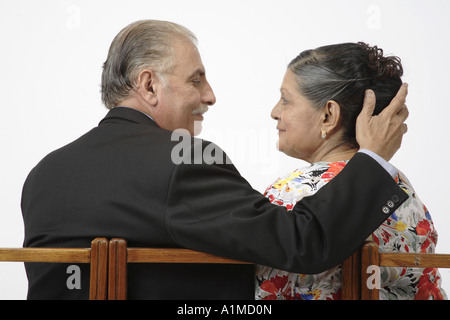 Loving Indian senior citizen couple wifes head in husbands hand Stock Photo