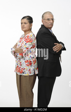Angry Indian senior citizen couple husband wife back to back fighting mood Stock Photo