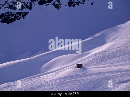 tracks of skiers in powdersnow at evening skier area of parsenn near resort of davos swiss alpes switzerland Stock Photo