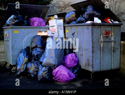 illegal household rubbish in commercial garbage dumpsters switzerland Stock Photo