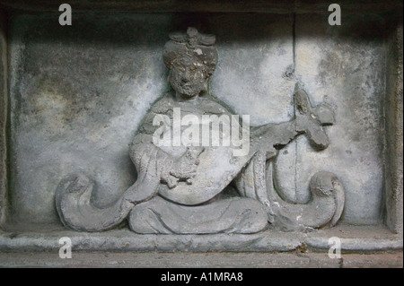 Carved figure of female musician holding traditional Chinese instrument Pipa in Yong Ling Tomb Chengdu Sichuan Province China Stock Photo