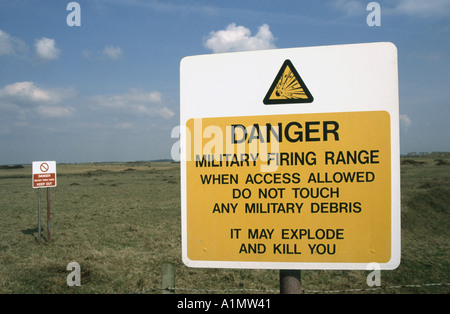 Cliff top signs National Park coastal footpath military firing range warning explosion of military debris Castlemartin Pembrokeshire South Wales UK Stock Photo