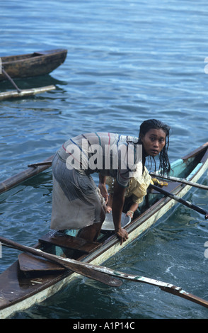 Badjao Badjau or Tau Laut sea gypsies children Puerto Princesa Palawan Philippines In outrigger canoe Dive for coins in water Stock Photo