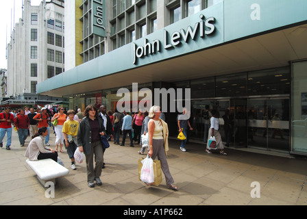 West End of London City of Westminster Oxford Street shoppers walking outside John Lewis department store frontage & canopy sign entrance England UK Stock Photo
