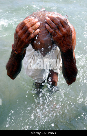 A Hindu pilgrim takes a dip in the Ganges in Haridwar in India Stock Photo