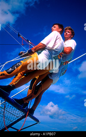 Eighteen foot skiff racing with crew of three on trapeze at Hayman Island Queensland Australia Stock Photo