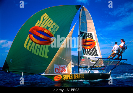 18 foot skiff racing with crew of three on trapeze at Hayman Island Queensland Australia Stock Photo