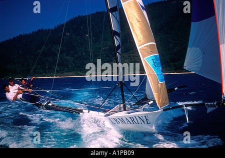 18 foot skiff racing with crew of three on trapeze at Hayman Island Queensland Australia Stock Photo