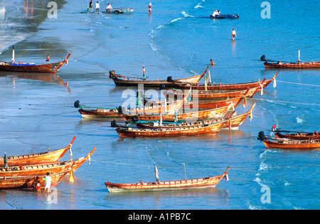 Traditional longtail boats pulled up at the beach Phuket Thailand Stock Photo