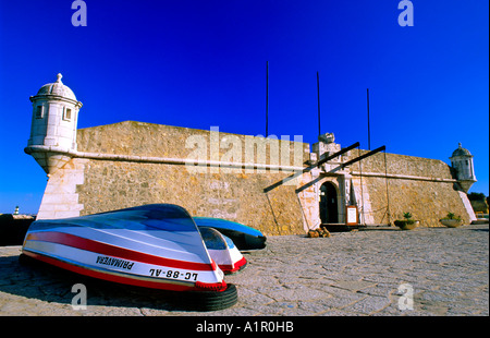 Fisherboat lying in front of the Fortress Pau da Bandeira, Lagos, Algarve, Portugal, Europe Stock Photo