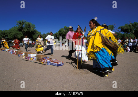 An Apache girl dressed in buckskin dress runs during her Sunrise Dance on the San Carlos Indian Reservation Arizona USA Stock Photo