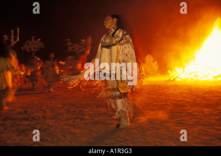 Apache girl and mountain spirits dance beside a bonfire at a Sunrise Dance on the San Carlos Reservation Arizona USA Stock Photo